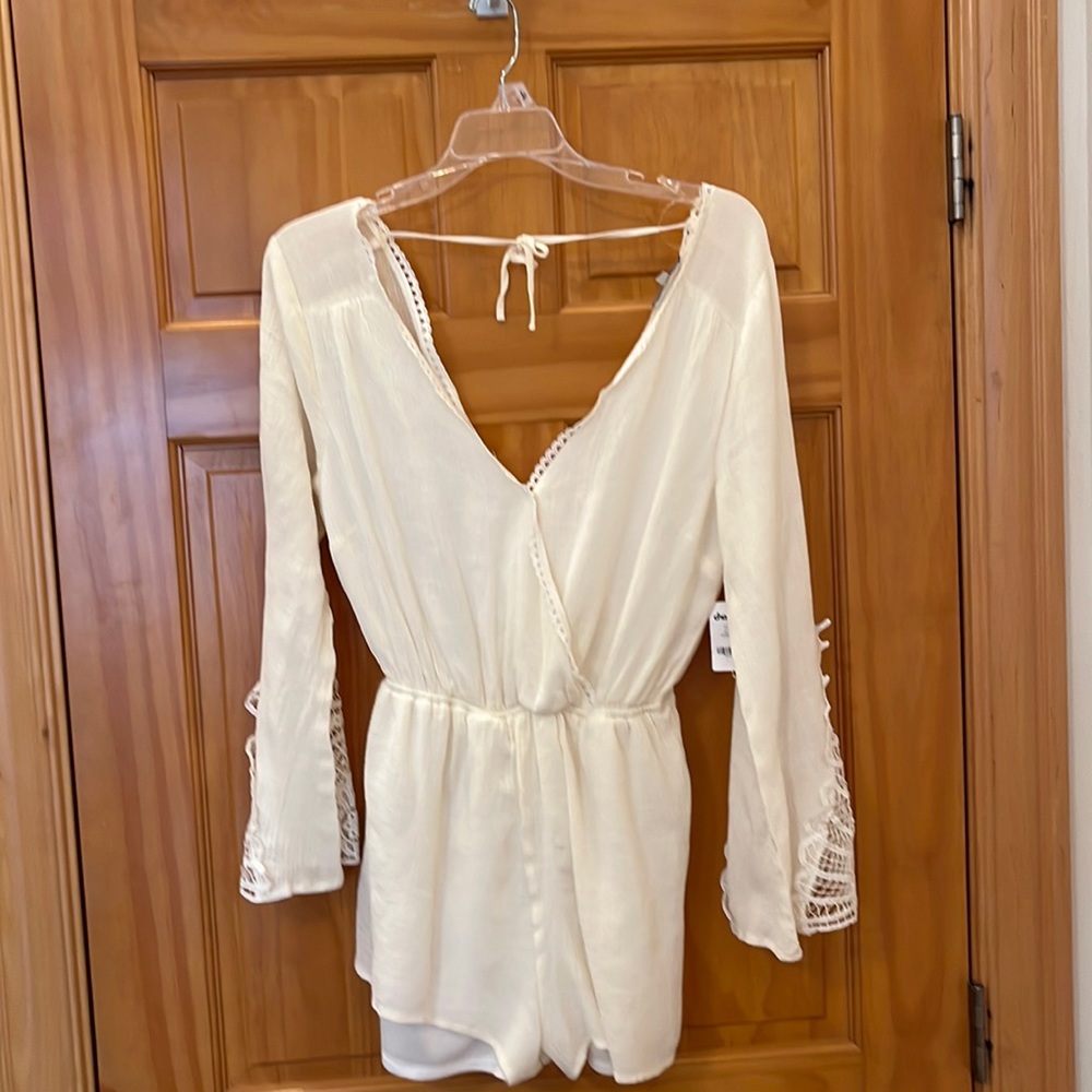 NWT cream romper with lace sleeve inset